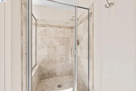 a bathroom with a glass shower door