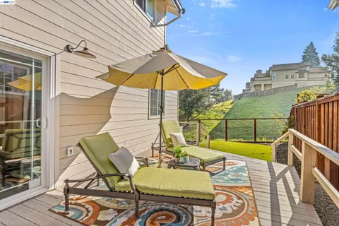 a view of a chair and tables in the balcony