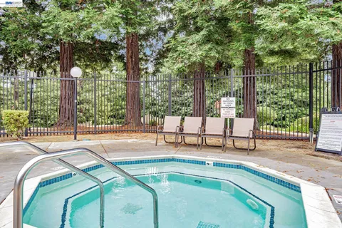 a swimming pool with outdoor seating and outdoor seating
