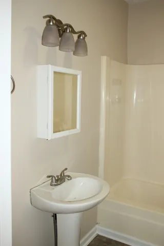 a bathroom with a sink a mirror and a shower