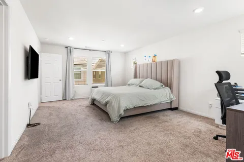 a bathroom with double sink a mirror and a window