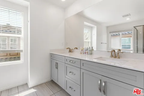 a bathroom with a sink vanity and mirror