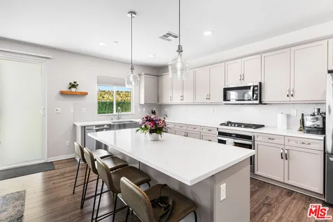 a kitchen with a sink stove top oven and cabinets