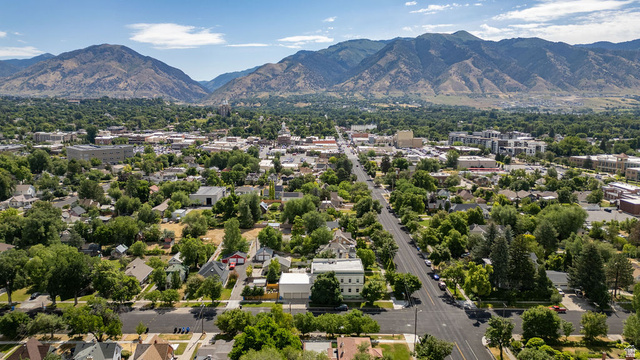 299 West Center Street, Unit 2 Logan, UT 84321 - Photo 40 of 46 Aerial perspective showcasing a verdant landscape with extensive tree canopy, residential streets, and commercial buildings