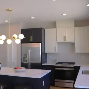a kitchen with kitchen island a sink stainless steel appliances and cabinets