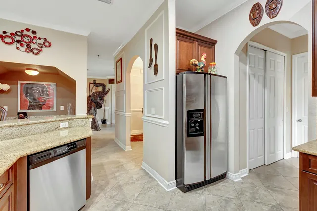 a dining room filled with furniture and a large window
