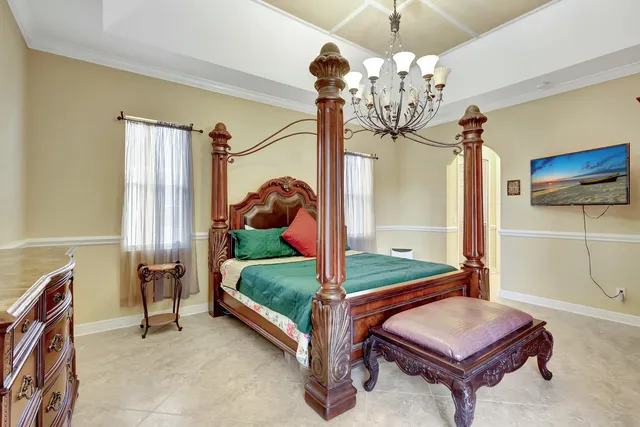 a bedroom with a bed and a chandelier