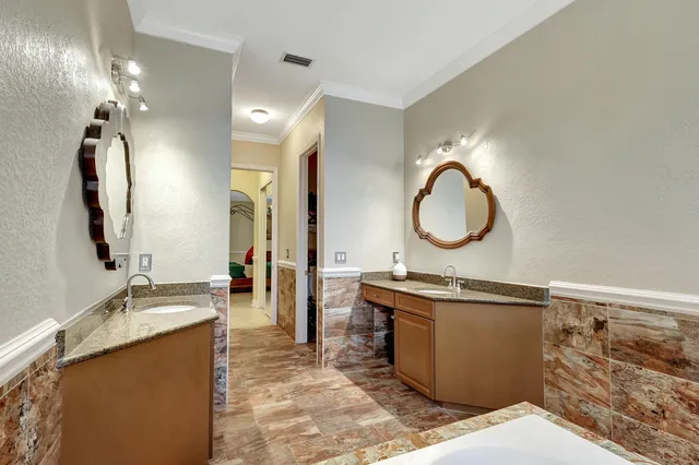 a bathroom with a sink mirror and vanity