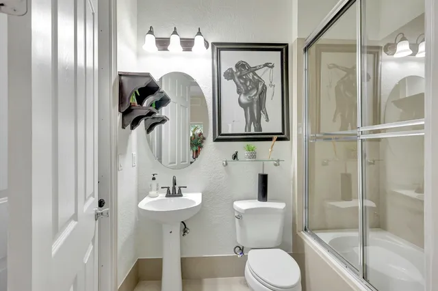 a bedroom with a bed and painting on the wall