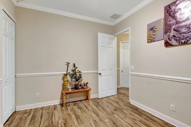 a view of empty room with wooden floor