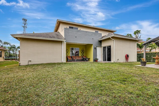 a backyard of a house with table and chairs