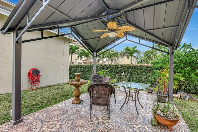 a view of a chair and table in backyard