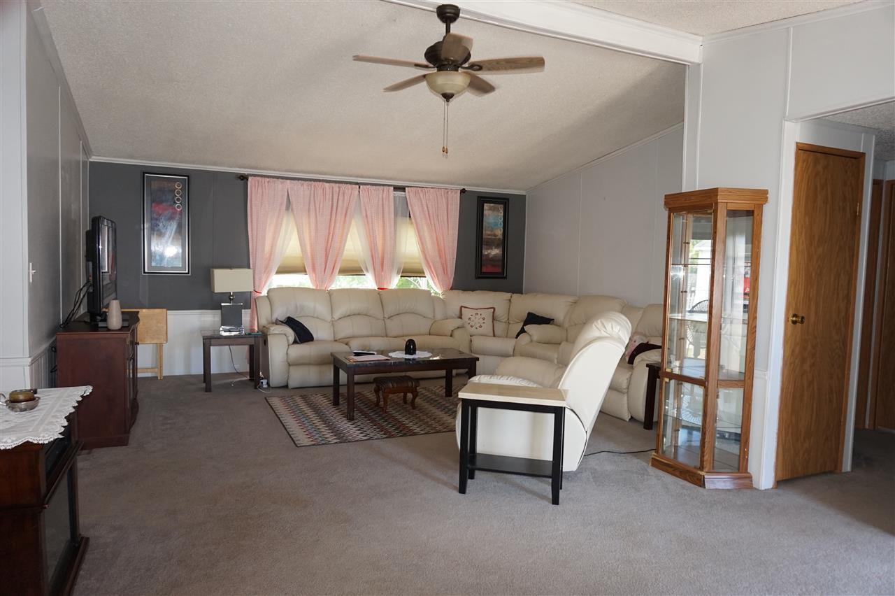 5134 Rockberry Road Loves Park, IL 61111 - Photo 11 of 24 a living room with furniture and a chandelier