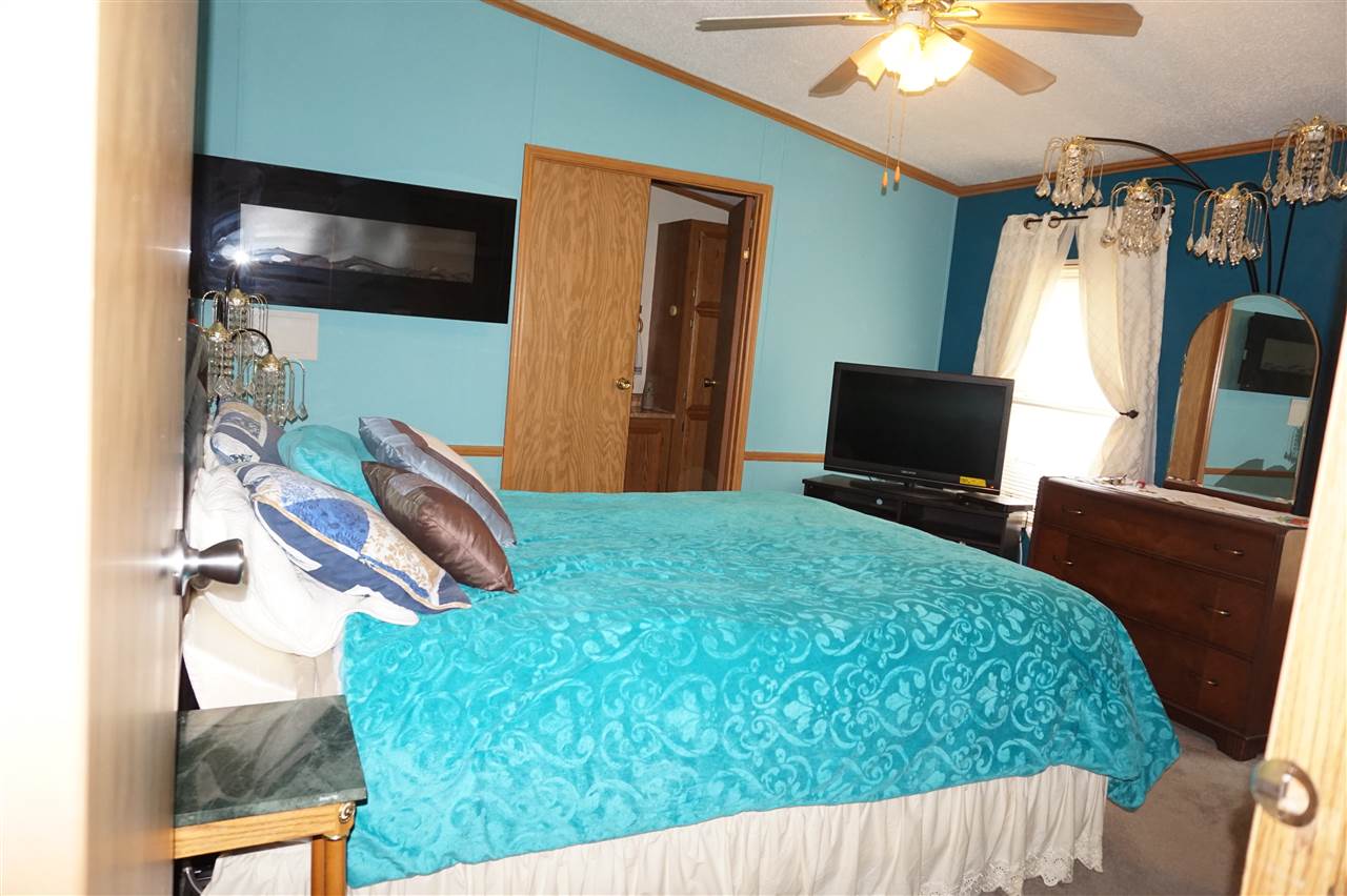 5134 Rockberry Road Loves Park, IL 61111 - Photo 17 of 24 a bedroom with bed and a chandelier