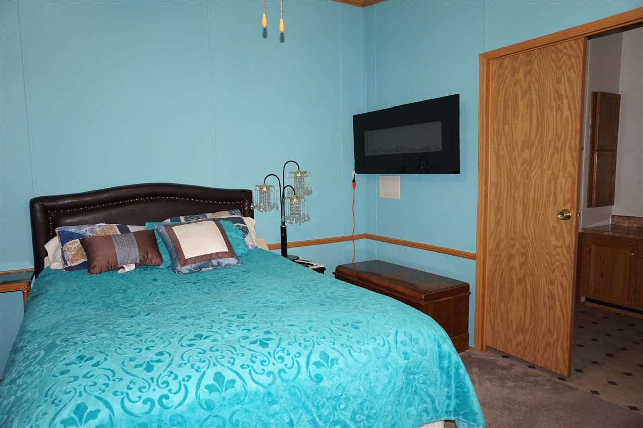 5134 Rockberry Road Loves Park, IL 61111 - Photo 18 of 24 a bedroom with a bed and a flat screen tv