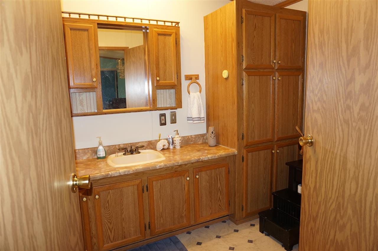 5134 Rockberry Road Loves Park, IL 61111 - Photo 19 of 24 a bathroom with a granite countertop sink and a mirror