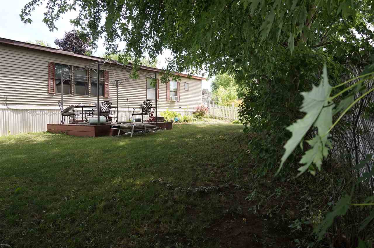 5134 Rockberry Road Loves Park, IL 61111 - Photo 2 of 24 a backyard of a house with table and chairs and potted plants