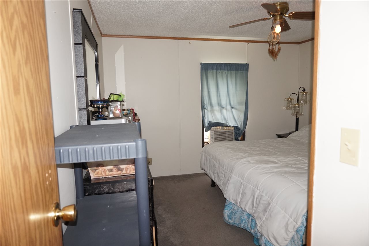 5134 Rockberry Road Loves Park, IL 61111 - Photo 22 of 24 a bedroom with a bed and a mirror