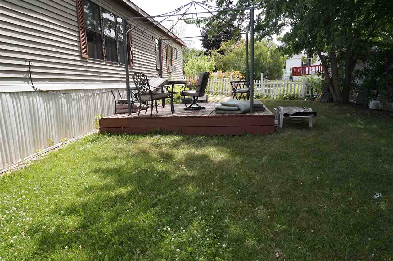 5134 Rockberry Road Loves Park, IL 61111 - Photo 4 of 24 a view of a chair and tables in the back yard of the house