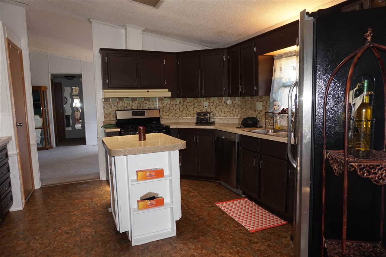 5134 Rockberry Road Loves Park, IL 61111 - Photo 7 of 24 a kitchen with a sink a microwave a refrigerator and cabinets