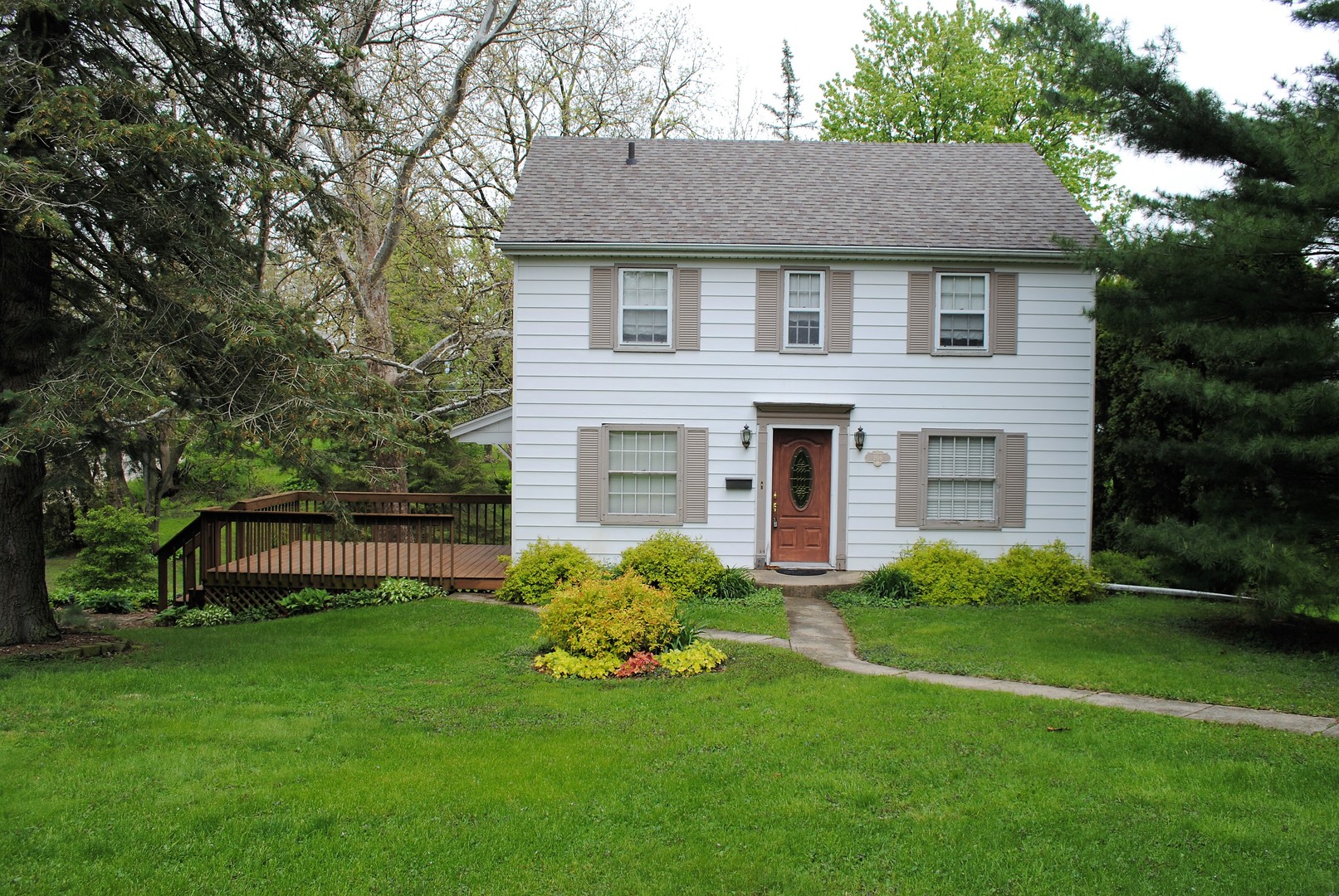 208 Ridge Street Mount Carroll, IL 61053 - Photo 1 of 16 a front view of a house with a garden and plants