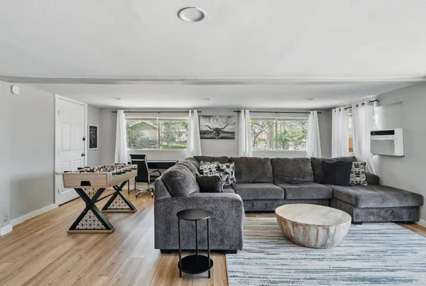 a living room with furniture and a wooden floor