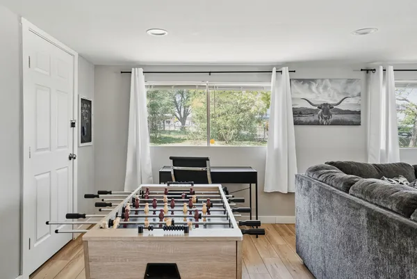 a living room with furniture and a floor to ceiling window
