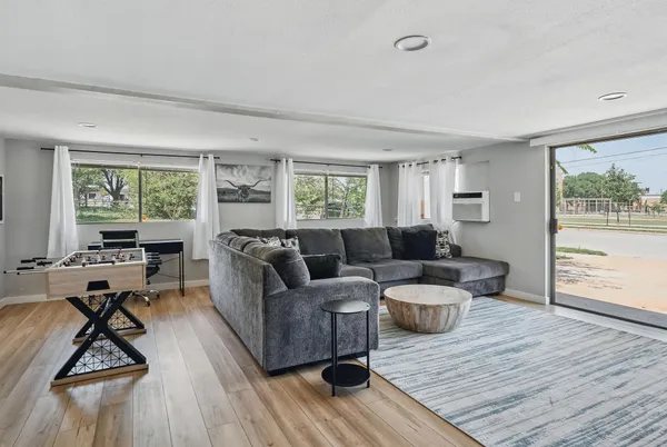 a living room with furniture and a wooden floor