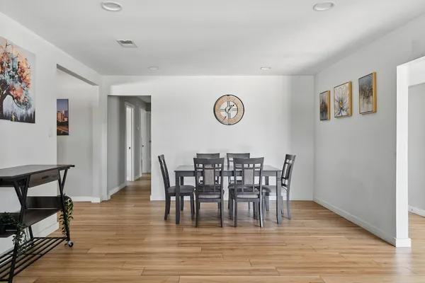 a view of a dining room with furniture and wooden floor
