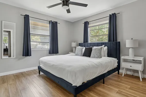 a large bed sitting in a bedroom next to a window