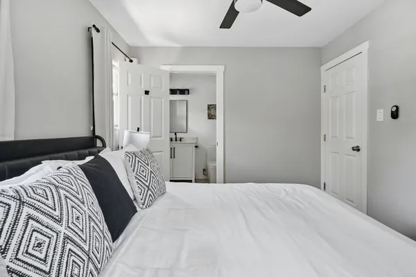 a bedroom with a bed and a chandelier