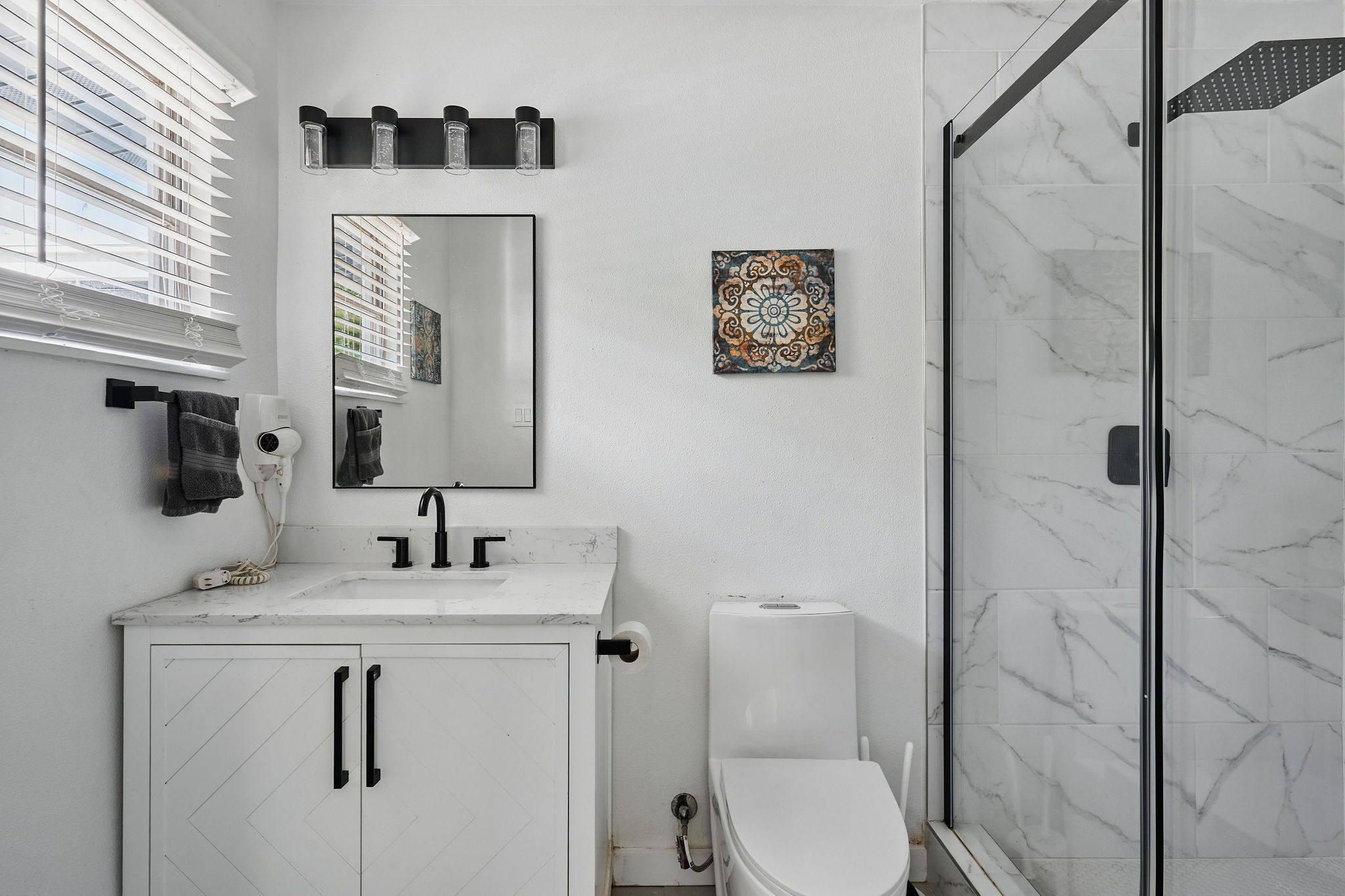 7706 Delafield Lane Austin, TX 78752 - Photo 23 of 28 Full bathroom with vanity and a marble finish shower