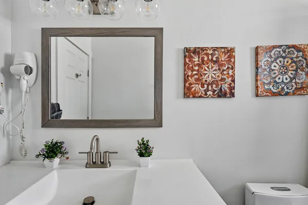 a bathroom with a bathtub a sink a toilet and a mirror
