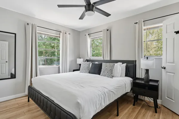 a large bed sitting in a bedroom next to a window