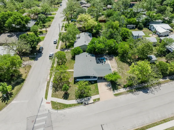 an aerial view of a house with a yard and garden