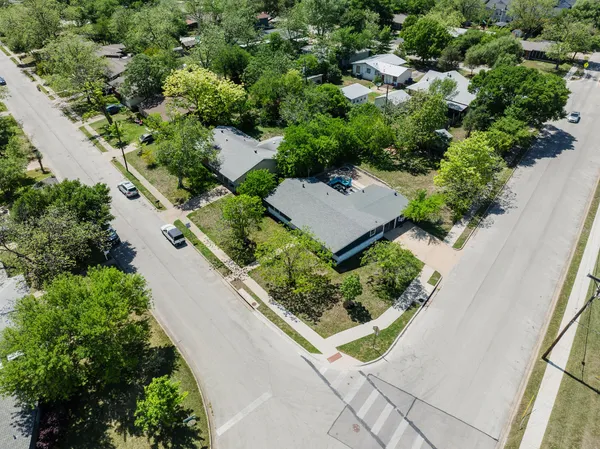an aerial view of a house with a yard and outdoor seating
