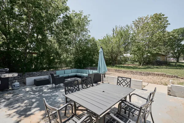 a view of backyard with seating area and green space