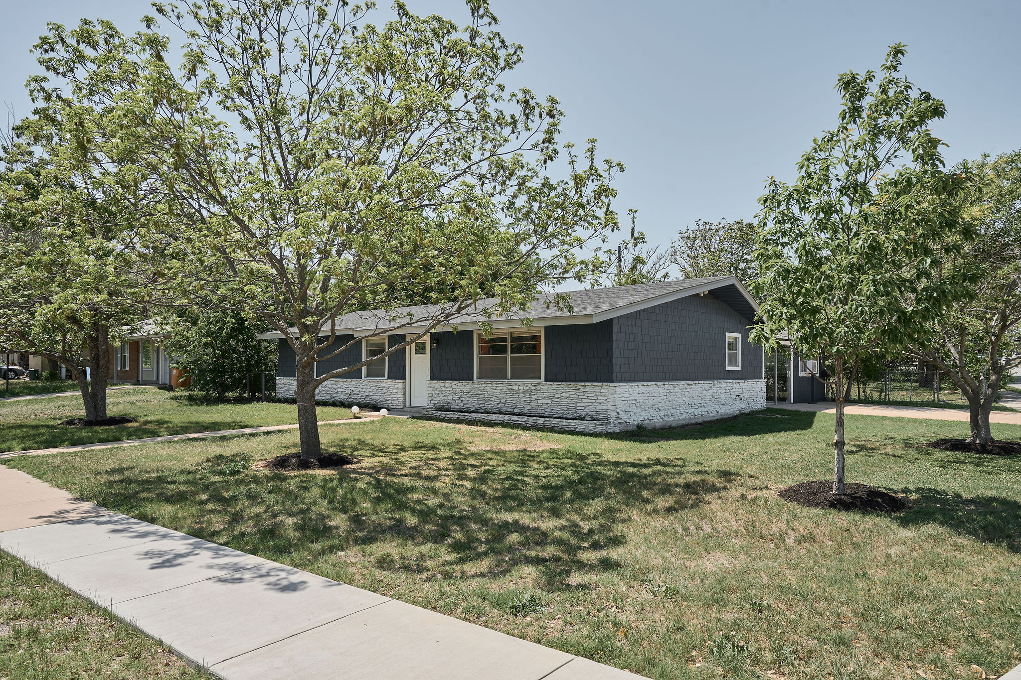 7706 Delafield Lane Austin, TX 78752 - Photo 8 of 28 View of front of property featuring a front lawn and stone siding