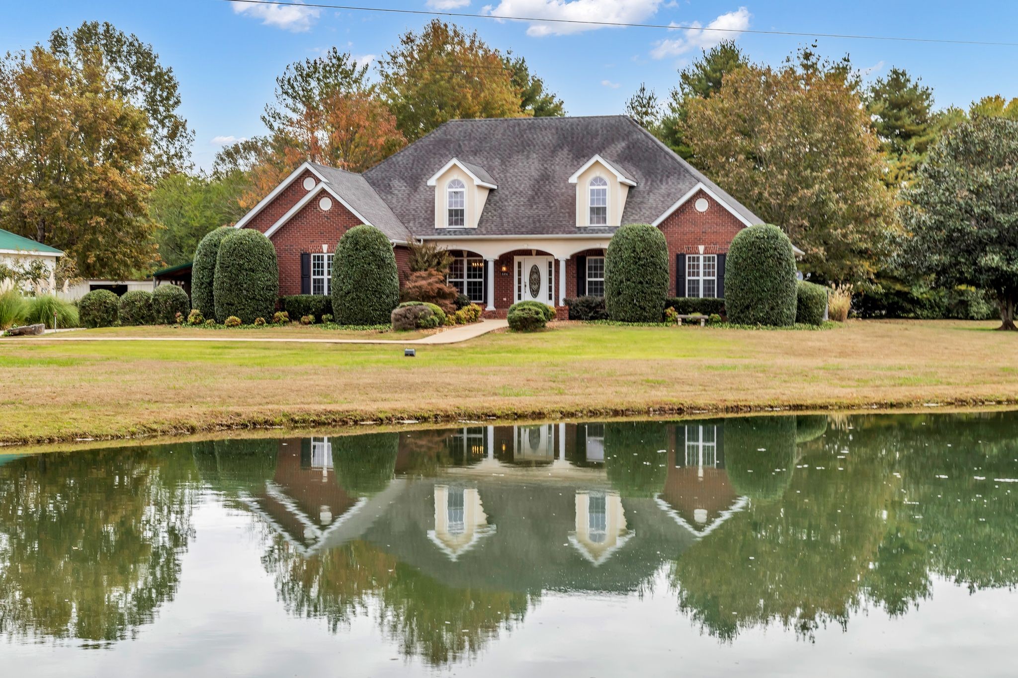 a front view of a house with a lake view