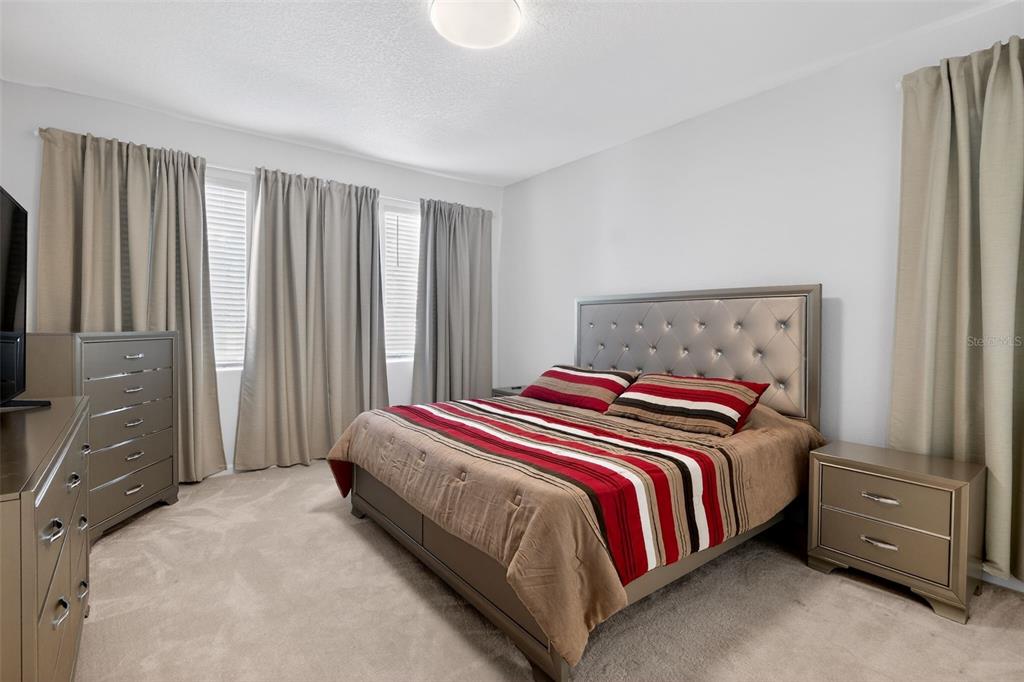 4577 Cabello Loop Kissimmee, FL 34746 - Photo 14 of 37 a bedroom with a bed and a window