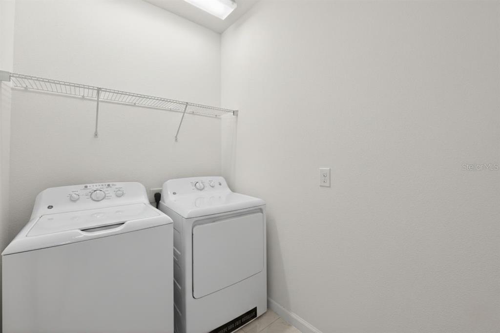 4577 Cabello Loop Kissimmee, FL 34746 - Photo 18 of 37 a utility room with dryer and washer