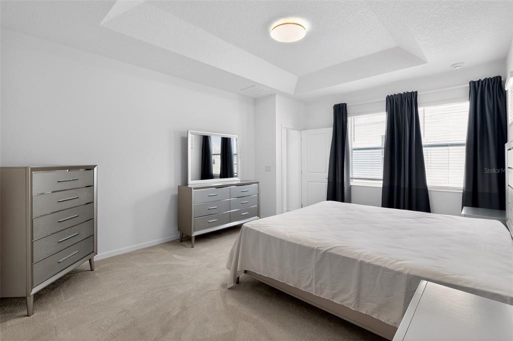 4577 Cabello Loop Kissimmee, FL 34746 - Photo 20 of 37 a bedroom with a bed and a large window