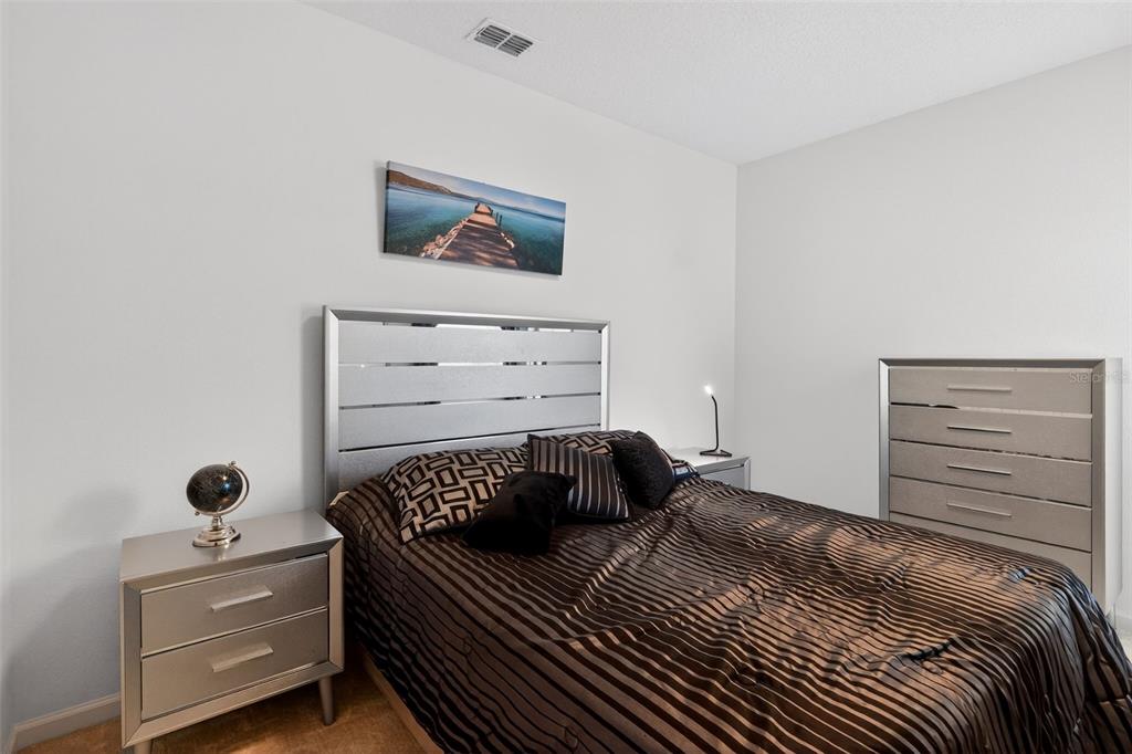 4577 Cabello Loop Kissimmee, FL 34746 - Photo 22 of 37 a bedroom with a bed and a closet