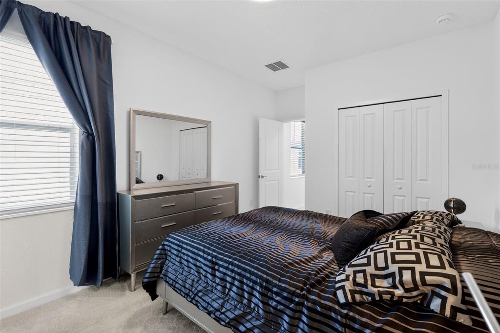 4577 Cabello Loop Kissimmee, FL 34746 - Photo 23 of 37 a bedroom with a bed and wooden floor