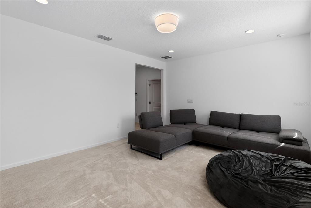 4577 Cabello Loop Kissimmee, FL 34746 - Photo 25 of 37 a living room with furniture and a rug