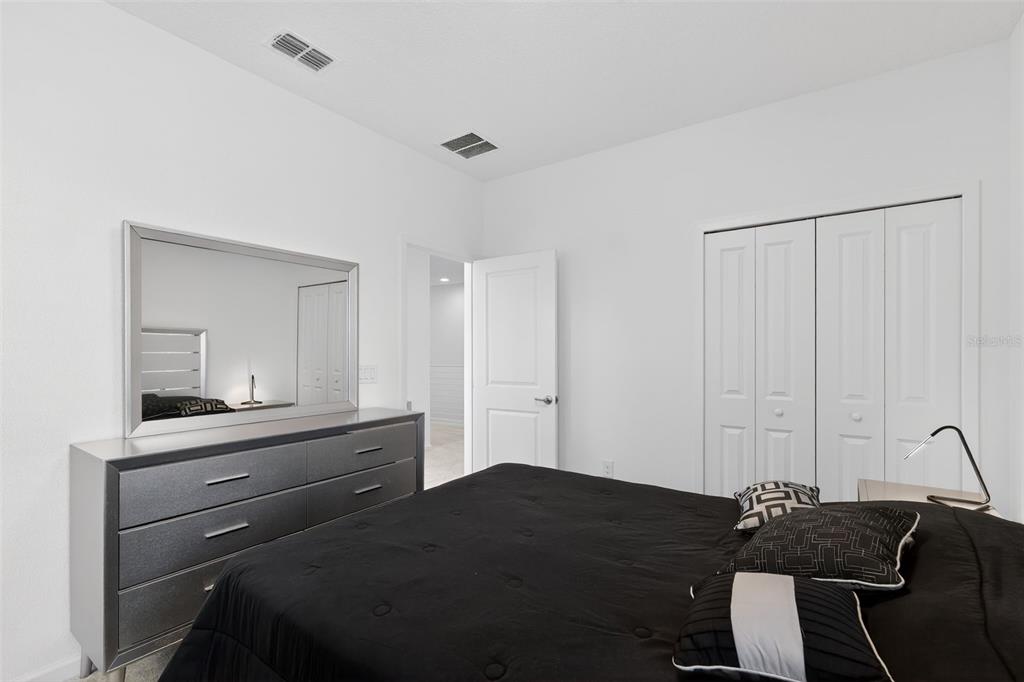 4577 Cabello Loop Kissimmee, FL 34746 - Photo 31 of 37 a bedroom with a bed and a dresser