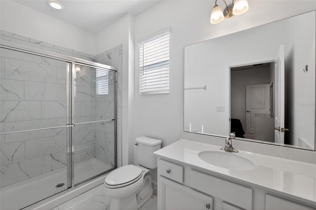 4577 Cabello Loop Kissimmee, FL 34746 - Photo 32 of 37 a bathroom with a sink toilet and shower