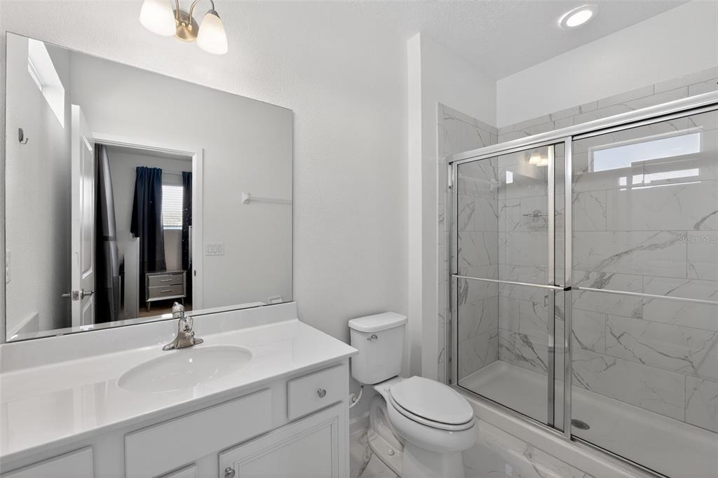 4577 Cabello Loop Kissimmee, FL 34746 - Photo 35 of 37 a bathroom with a sink toilet and shower