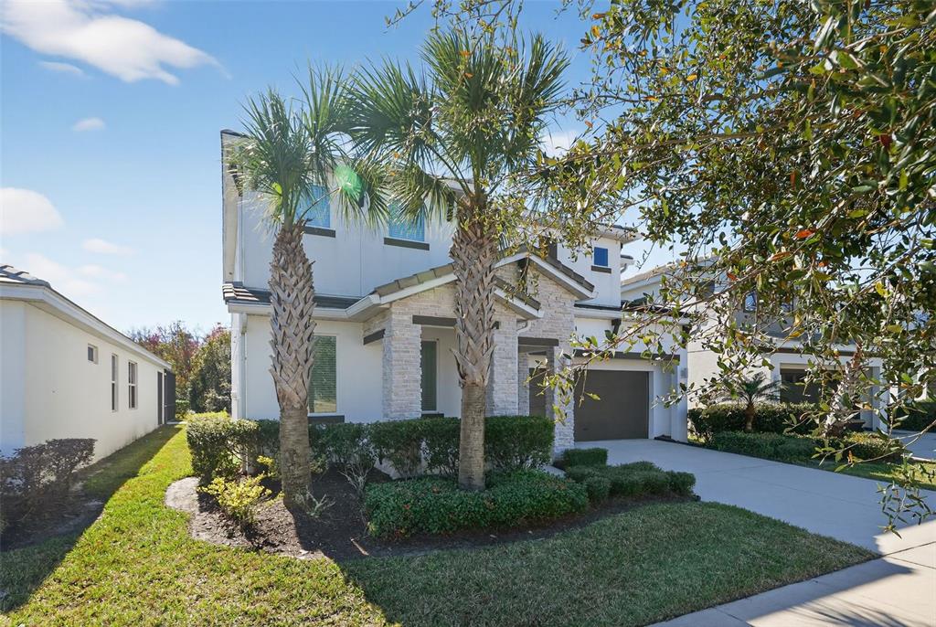 4577 Cabello Loop Kissimmee, FL 34746 - Photo 37 of 37 a front view of a house with a yard and potted plants