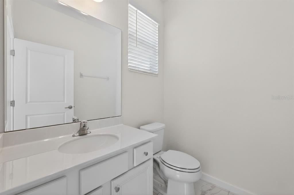 4577 Cabello Loop Kissimmee, FL 34746 - Photo 10 of 37 a bathroom with a sink toilet and a mirror